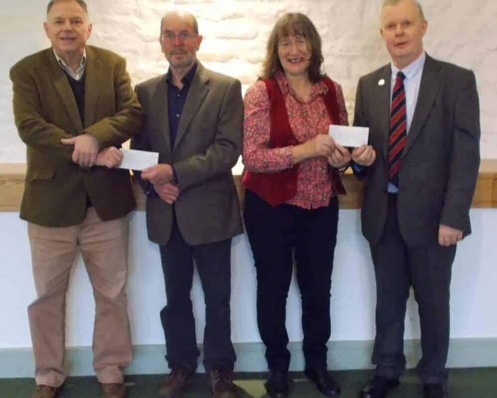Two cheques totalling over £1,000 being donated to the Wells and Mendip Museum from the proceeds of local book ‘Big Shows: Charles Heal and Sons’ written by local history authors Richard Green of Wells and Guy Belshaw from Wellington.