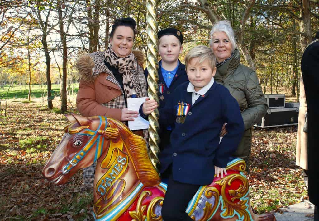 Photo - Guild Past President, the late Jimmy Williams, was instrumental in securing the Guild’s own memorial at the National Memorial Arboretum and the Galloper horse is named ‘James’ after him. Attending the service were Mrs Vicki Williams, daughter Linzi Freemen and grandsons Tommy (standing) and Jimmy (seated). The boys are wearing their great great grandad Joseph (Jos) Williams’ and great grandad James Williams’ medals from World War I and World War II respectively.