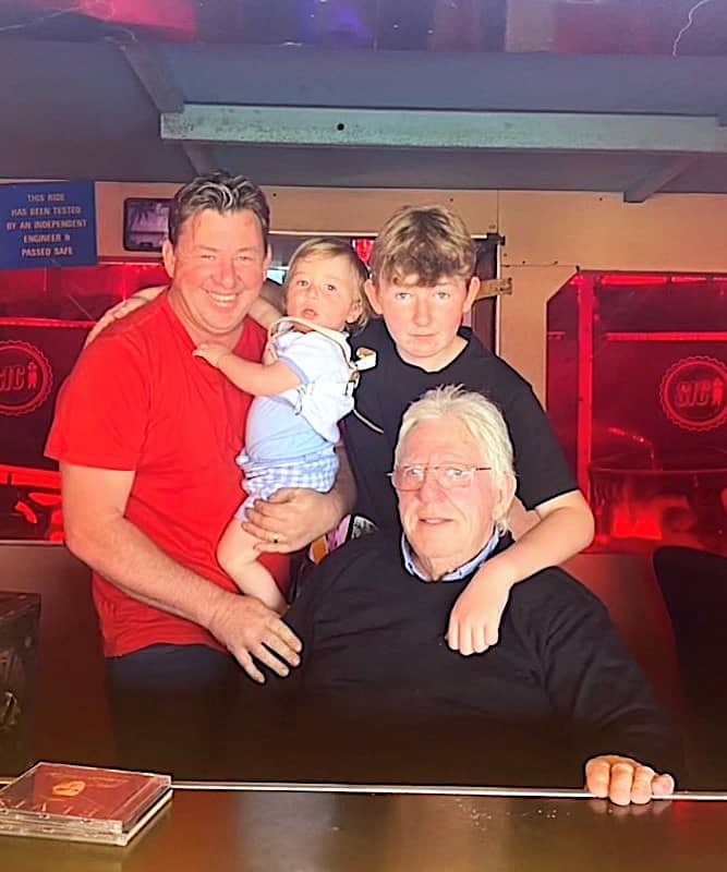 Terry Atha Jnr in the waltzer paybox with sons Presley and Bobby and his father Terry.