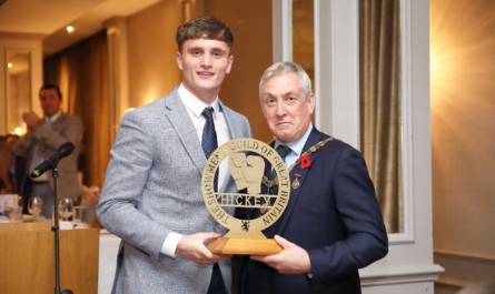 Commonwealth Gold Medal winner Sam Hickey receives a trophy from the Scottish Section Chairman Alex James Colquhoun.