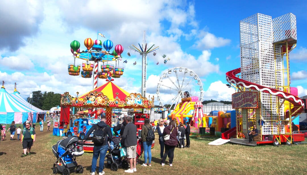Crowds enjoying the funfair in the sun at the Yorkshire Balloon Fiesta.