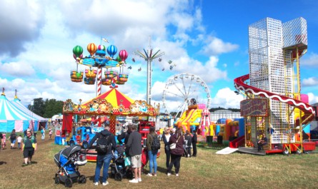 Crowds enjoying the funfair in the sun at the Yorkshire Balloon Fiesta.